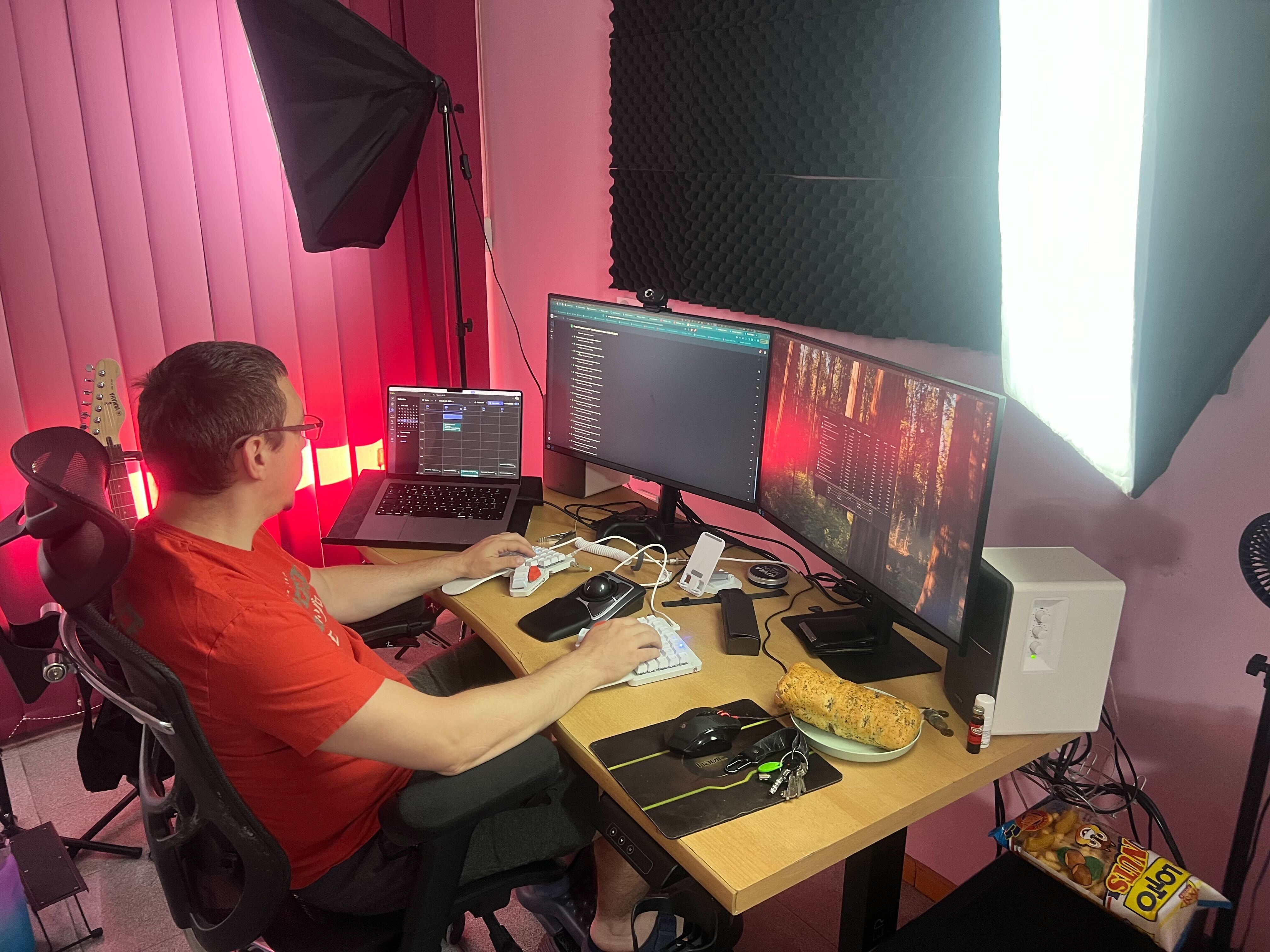 Colleague working at home with triple-monitor setup